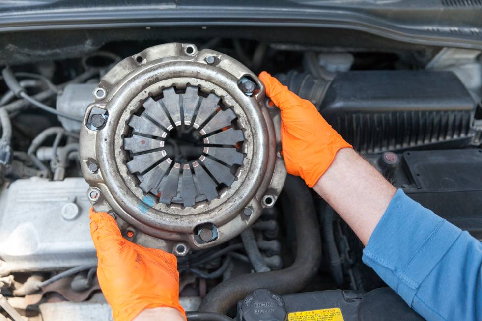 a person holding a part of a car