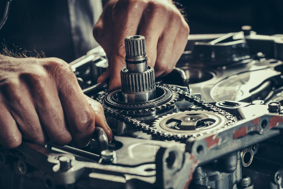 Close up of hands of a person working on a machine